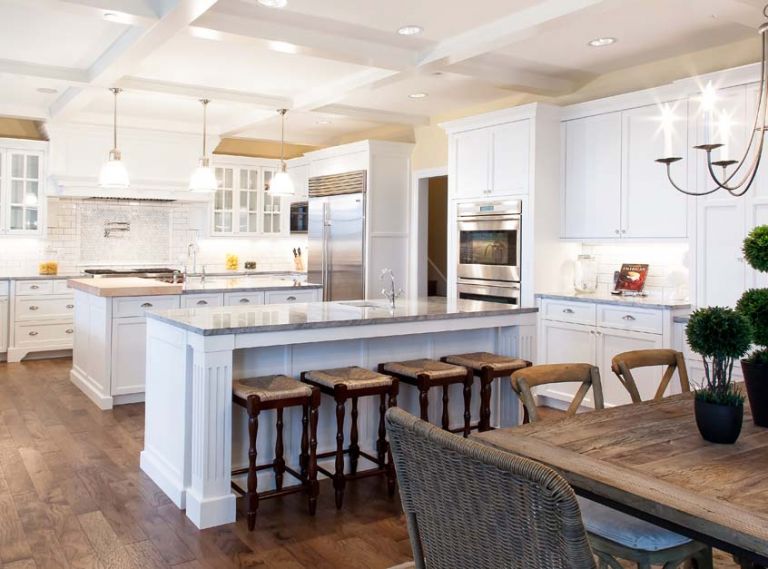The floor plan of this Vancouver, Washington kitchen designed by Andy Morr of Hayes Cabinets is thoughtful, creating spaces where you know exactly what you’re supposed to do. The abundance of white takes advantage of the natural light but is offset with the sheen of the grey marble and the warmth of the rustic wood tones.