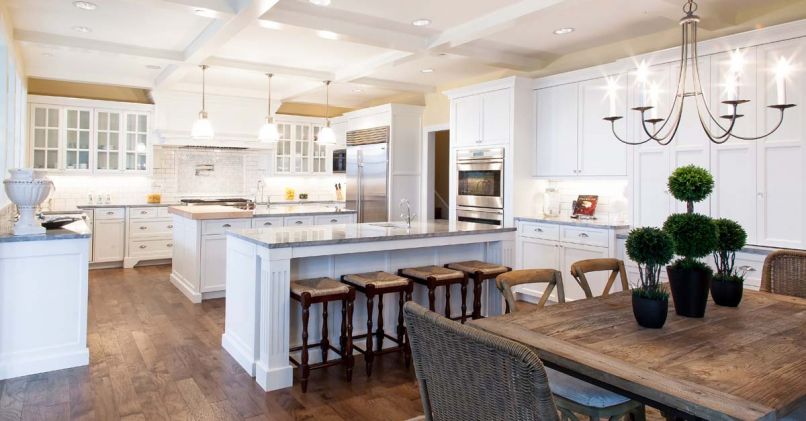 The floor plan of this Vancouver, Washington kitchen designed by Andy Morr of Hayes Cabinets is thoughtful, creating spaces where you know exactly what you’re supposed to do. The abundance of white takes advantage of the natural light but is offset with the sheen of the grey marble and the warmth of the rustic wood tones.