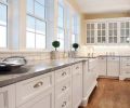 Classic chrome cup pulls were used on the drawers in the kitchen, but Morr added a special touch with crystal pulls on the cabinets. They sparkle in this light-filled kitchen.