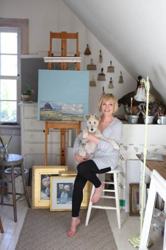 Diane in her upstairs studio with their fox terrier Lily.