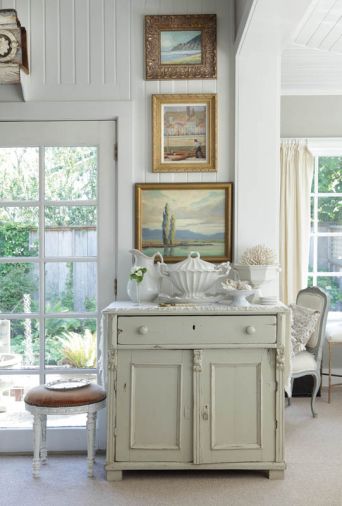 Jay installed French doors that lead to the garden at left. Diane’s painting of Neahkahnie Head tops another painting by Jay’s great uncle and a California plein air painting of Salinas Valley. A Redcliffe ironstone tureen resembling a sea shell sits atop an antique Romanian chest.