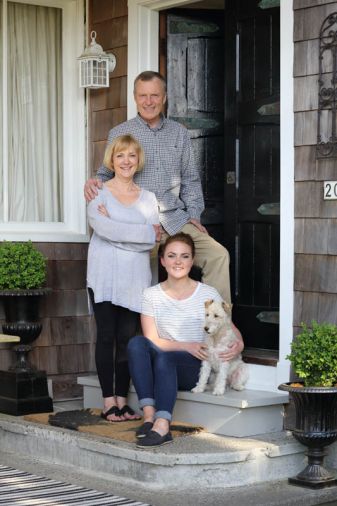 Jay, Diane, Rachel and Lily gather on the porch, formerly a typical wraparound style until previous owners enclosed it as part of the living area.