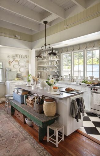 A rustic Arteriors kitchen chandelier presides over the island, and a green bench from Santa Fe displaying cherished antiques. “I was with three other dealers when I spotted that rare pickle barrel,” recalls Diane. “The outside is yellow ware, the inside white porcelain, with a wooden top. Must have been a promo piece that failed because the customers couldn’t see the pickles!” An 1800s pine pie safe with dovetail construction (on back counter) is the first antique Diane ever purchased. “It was the 1970s, and, unfortunately, the dealer had stripped the white paint. Later, I repainted it!”