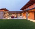 Reverse pitched roofs found above the main entry and the U shaped courtyard’s storage building echo Eichler designs.