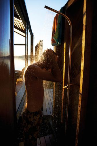 One of the design’s many hidden pleasures is an outdoor shower slotted behind a wall preserved from the old garage.