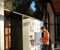 A crisp custom Corian bookcase hides a bar, an electrical outlet and, on its other side, the front door.