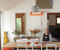 The dining area of the remodeled kitchen is so successful that the couple turned the home’s formal dining room into a library. A wall-hung orange paper cutter holds a roll of paper for children’s artwork or for adults’ games of Pictionary. The table and chairs are from Ikea while the orange stool is from Wayfair. Often the hub of all activities, the kitchen was designed with enough open space for family and guests to congregate and socialize.