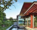 The north end of the Pavilion House cantilevers over a reflecting pool and a lush paradise garden for spring and summer viewing enjoyment. Landscape architecture by Charles Anderson.