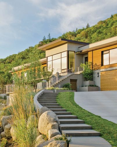 The exterior of this LEED-Platinum Certified custom home is primarily sanded concrete, which creates a uniform, finely textured finish. Sanded concrete is also used throughout the landscaping, including stairs and landings. Cedar wood cladding adds warmth as well as a direct connection to the home’s surroundings. These planks were milled from trees grown within 50 miles in sustainably managed forests.