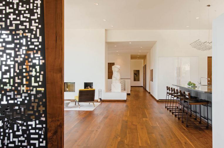A custom bust by M.J. Anderson anchors one corner of the great room. “I love how we incorporated a sculpture in the space,” says Fillinger. The rough shape for the bust was created in Carrara, Italy, a town famous for its crystalline white marble, before being shipped to Anderson’s studio on the Oregon Coast for finishing.