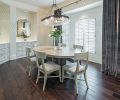 The 18 month long project started in the dining room. Sage green walls were papered in a light pattern, new mirrors were hung to reflect the light and cabinetry was transformed with paint.