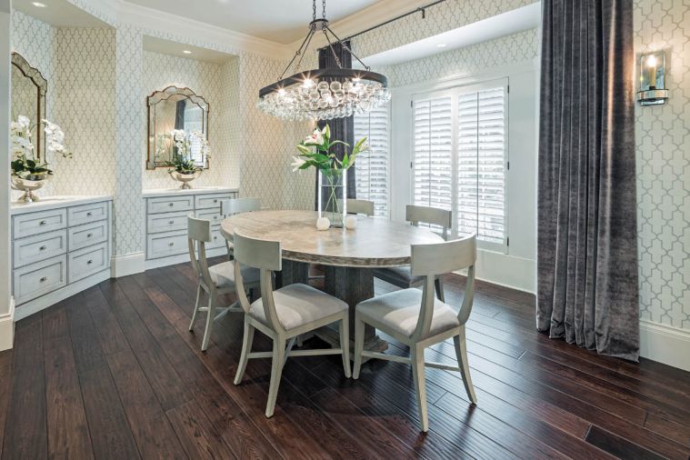 The 18 month long project started in the dining room. Sage green walls were papered in a light pattern, new mirrors were hung to reflect the light and cabinetry was transformed with paint.