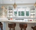 The kitchen was transformed by a refresh rather than a remodel; both the appliances and the footprint were retained by the homeowners. The only structural change introduced by Baines was to remove the upper cabinets that flanked the kitchen window. In their place, a new marble backsplash extends up the wall from the counter to the ceiling.