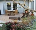 The shady side of the house doesn’t have to be drab. In this low-light planting, Tish mixes Helleborus ‘Pink Frost’ and Brunnera macrophylla ‘Jack Frost.’