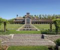Step down reflecting pools draw the eye toward the arbors.