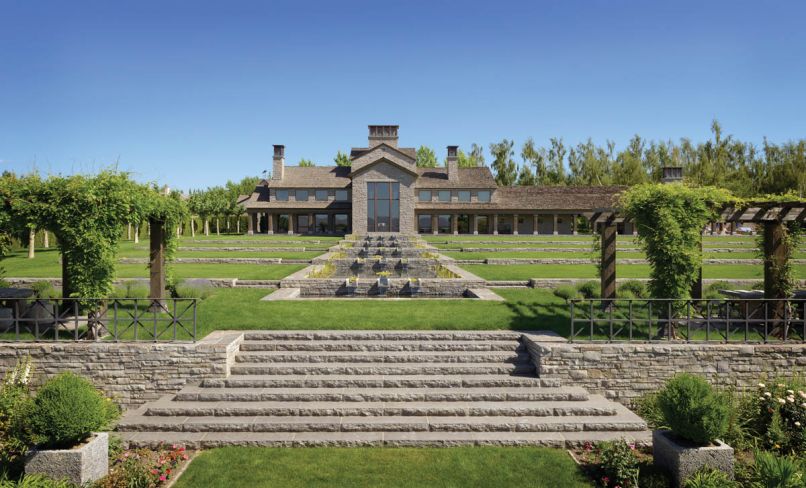 Step down reflecting pools draw the eye toward the arbors.