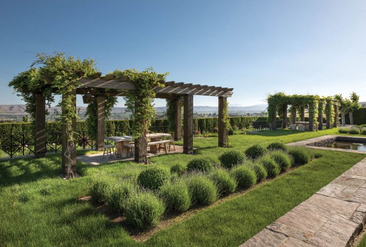 David Smith & Co. supplied the millstone table and chairs beneath the arbor.