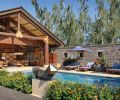 Doug Rasar and Rod Knipper worked with Josh and James Sevigny of Artisan, Inc. to turn a very utilitarian garage area into the colorful Hawaiian style cabana, tying it to the main estate by facing a concrete block wall with the same Oklahoma quarried limestone found on the home’s facade. Mammoth Douglas fir logs are wrapped in hemp rope; Jeld-Wen bi-folding doors close off the cabana in winter. Peter Millet bronze statue.