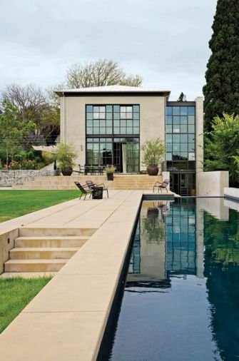 The southern and western sides of the building are dominated by windows, including expansive French doors that can be opened to create a virtually seamless transition between the interior and exterior of the home. The windows are steel-framed with very narrow mullions, giving them a light feel and thin profile that further minimizes the transition from inside to outside.