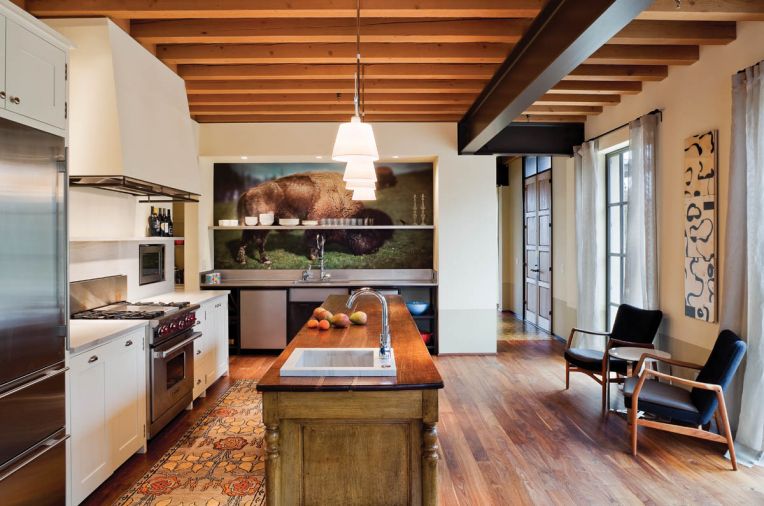 The bison image behind the main kitchen sink is one of the most striking design elements in the Southpaw home. Made from custom-printed wallpaper, the image posed some challenges. “It was a pretty interesting process to get ready. I had to track down the photographer in Germany to get the rights to use the photograph,” says Osolin. “And we had to use a slide to get proper resolution for such a large size.”