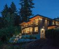 Glass railings ring the terrace off the master suite. Smith Rock stone is used at the entry.