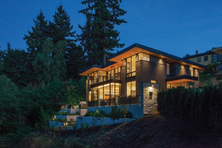 Glass railings ring the terrace off the master suite. Smith Rock stone is used at the entry.