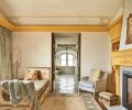 Hand painted antique day bed in the new master sitting area draws the eye to French doors opening onto master bath. Architects designed fireplace and surround. Fireplace tiles installed by Ambiente Tile.