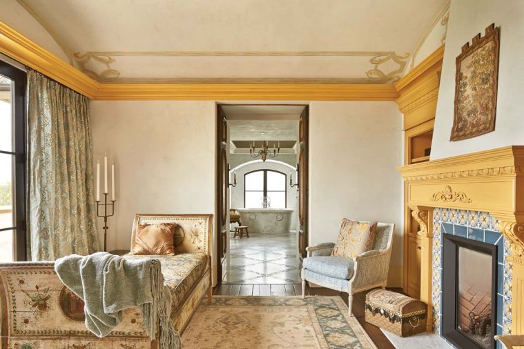 Hand painted antique day bed in the new master sitting area draws the eye to French doors opening onto master bath. Architects designed fireplace and surround. Fireplace tiles installed by Ambiente Tile.