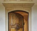The Great Northwest Door Company crafted the arch oak pivot entry door crowned with a hand painted fresco designed by Hyde Evans Design and executed by Cathy Conner of Studio C.