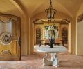 Parefeuille terra cotta tile flooring stretches beyond entry to dining room. To keep with Tuscan home traditions, no baseboards were used.