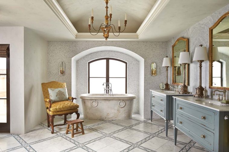 An indirectly lit period cove ceiling features Venetian plaster and reproduction chandelier - the latter is found replicated in the adjacent master bedroom’s vaulted ceiling. Carrara floor tile with ornate band designed by Hyde Evans. Antique upholstered chair found in San Francisco.