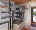 A central utility room off the garage gives easy access to all of the home’s systems, including the heat pump, 2,400 gallon UV-purified rainwater reclamation system, under-floor radiant heating, and pool systems.