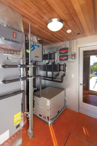 A central utility room off the garage gives easy access to all of the home’s systems, including the heat pump, 2,400 gallon UV-purified rainwater reclamation system, under-floor radiant heating, and pool systems.