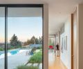 Facing the inner pool terrace, the workspaces afford great views of the outdoor living space and abundant natural light. The house, makes use of light-colored rift-cut white oak and walnut.