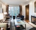 The living room features a custom hair on hide sofa frame with silk velvet cushions paired with Jean de Merry wing back “Laurent” chairs, and GCW lounge chairs in leather and fabric.