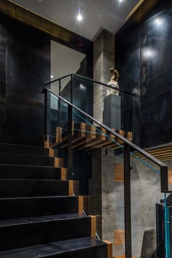 Andrew Patterson recalls unearthing old growth floor timbers in the stables, which they used as treads with a carpet runner of steel on the cantilevered staircase.