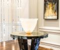 A Jean de Merry “Amalfi” entry table with mercury mirrored glass and bronze accents. Bronze staircase pickets by GCW. Artwork is from the client’s collection.