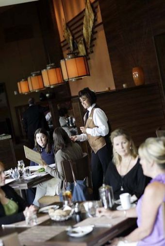 Elegant earth tones in the dining room at JORY set a serene and sophisticated scene.