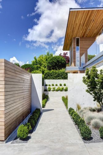 A cedar and concrete wall encloses a private garden.