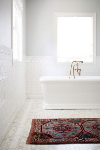 The master bath includes brass hardware, a traditional material that’s undergoing a contemporary revival. In order to mimic the distressed look of true antique hardware, all the lacquer was stripped from many of the fixtures so they could develop a natural patina.