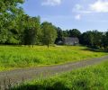 When coming upon the farmstead from a country road, the pool is completely hidden behind outbuildings used for storage of pool equipment
and furnishings in winter months