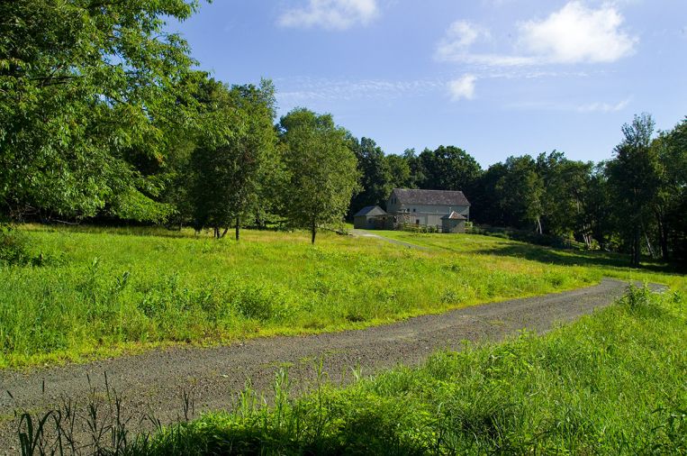 When coming upon the farmstead from a country road, the pool is completely hidden behind outbuildings used for storage of pool equipment
and furnishings in winter months