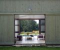 The larger outbuilding at left was designed as storage for pool furnishings during off seasons. To its left is the dramatic stone wall built from local stones – remnants from walls on the 200-acre property.