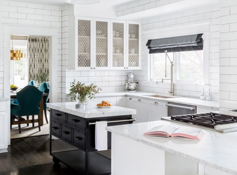 Dark and with limited counter space and storage, the kitchen provided the impetus for the remodel that would eventually touch almost every surface in the house. After painting existing cabinets and woodwork white, new cabinets and an island were added to expand the work areas.