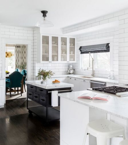 Dark and with limited counter space and storage, the kitchen provided the impetus for the remodel that would eventually touch almost every surface in the house. After painting existing cabinets and woodwork white, new cabinets and an island were added to expand the work areas.