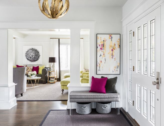 Located by the front entryway, the living room’s facelift not only included new paint but also a new granite surround for the fireplace. Created with the adults who would be using it in mind, furnishings here were deliberately chosen to have a more glamorous Hollywood-like aura than they have in the rest of the house. Chartreuse and magenta provide strong and warm colors against the cooler white and grays.