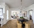 A large, gracious entryway
built for welcoming guests is one of the home’s most noteworthy features, but it also posed a design challenge. “I felt it was too naked to have nothing there,
too empty,” says Hester, so she placed a vintage black table in the center to add interest to the entryway. A crystal chandelier echoes the original plaster detail in the molding.