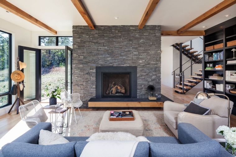 The colossal fireplace pays homage to the central hearths of rural French farmhouses — only with a few major upgrades, like gas flame and a stacked ledgestone that entirely conceals grout lines. “We designed most of the home around that centerpiece,” says Jordan.