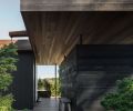 The home is structured around an internal courtyard that makes spending time in the outdoors easy. Rock gardens planted with evergreens and grasses evoke alpine terrain, while mellow cedar siding provides a soothing backdrop. © Andrew Pogue